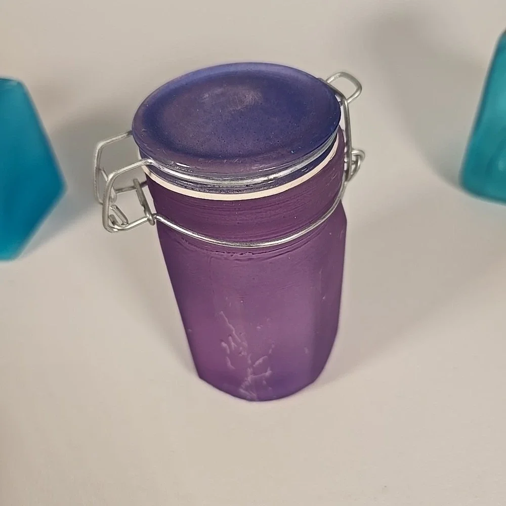 Set Of Four Colored‎ Glass Cannisters With Locking Tops Very Good Condition